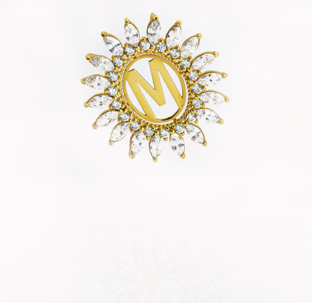 Dije de oro macizo de 18K con borde de circonitas en forma de M